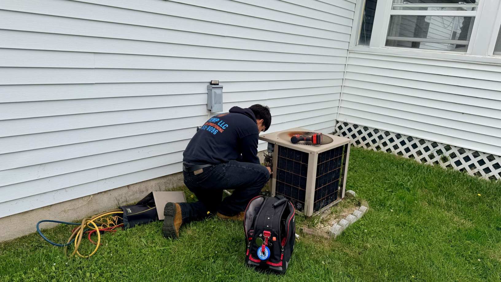 Cool Temp technician servicing an outdoor air conditioner